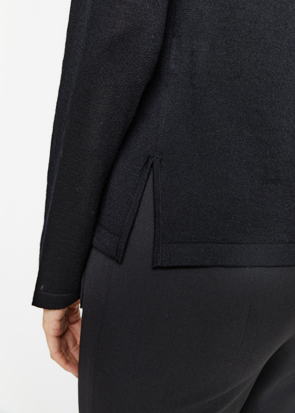 Détail fentes latérales pull col roulé en laine noir manches longues