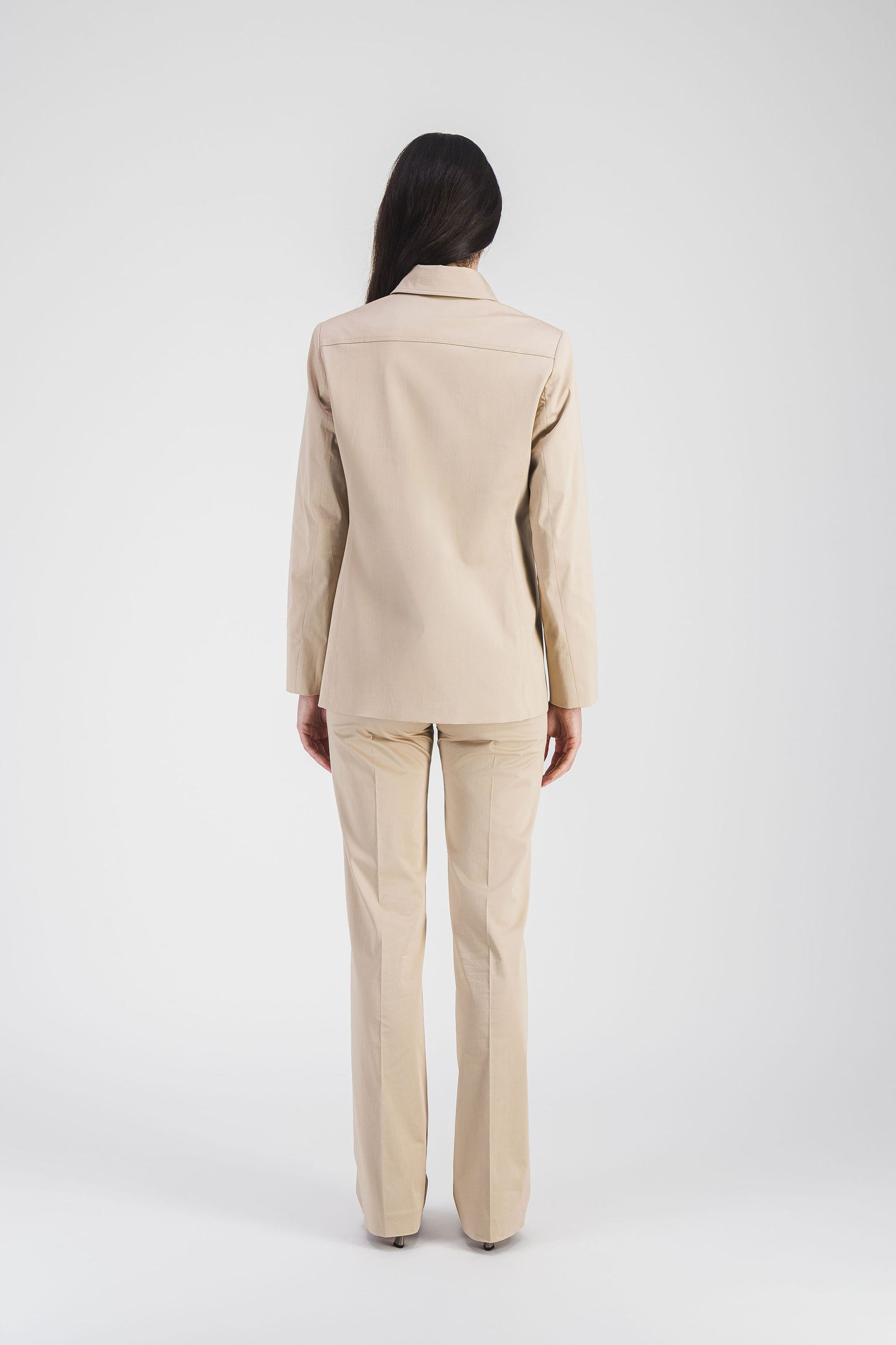 Veste beige en satin de coton, alliant confort et sophistication avec des détails soignés et des poches plaquées.