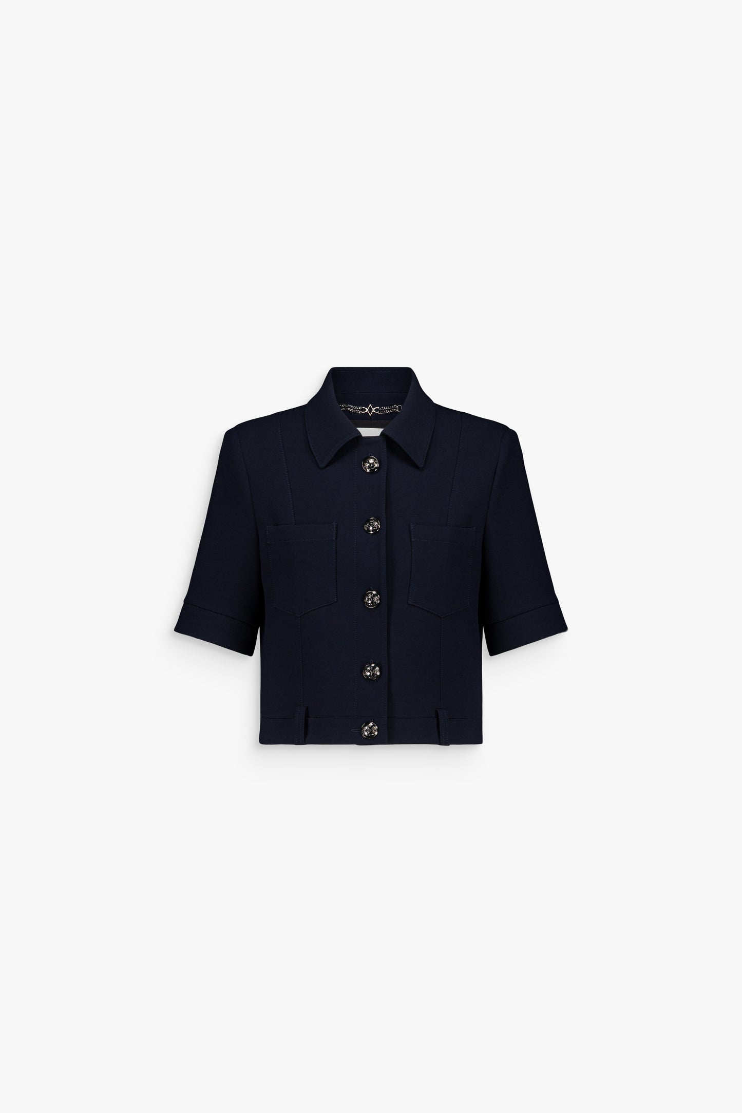 Veste courte marine à manches courtes avec col classique et boutons métalliques.