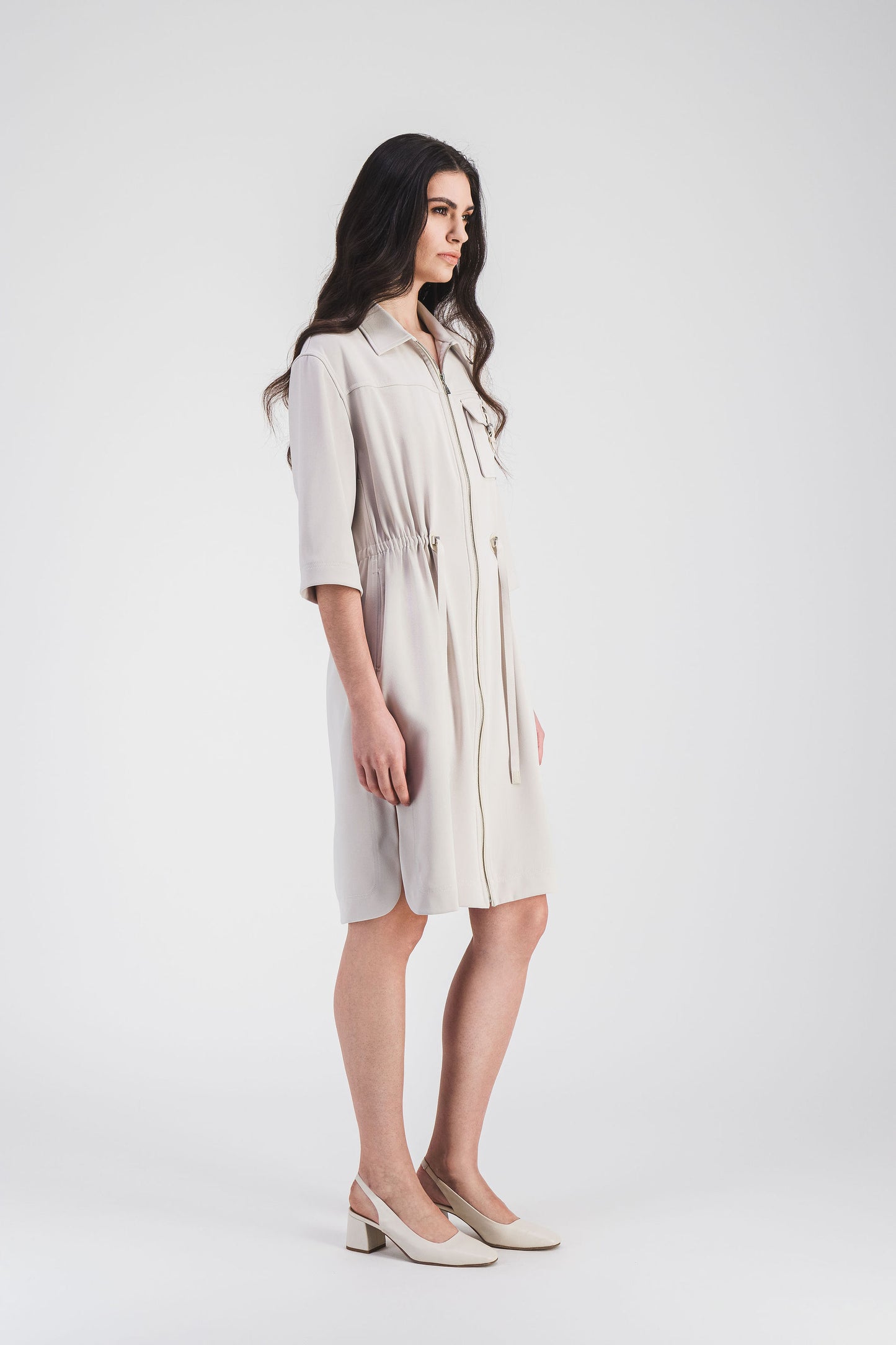Robe courte surchemise avec coupe droite, manches 3/4 et poche plaquée décorée d'une boucle métallique, cordon de serrage sur la taille.