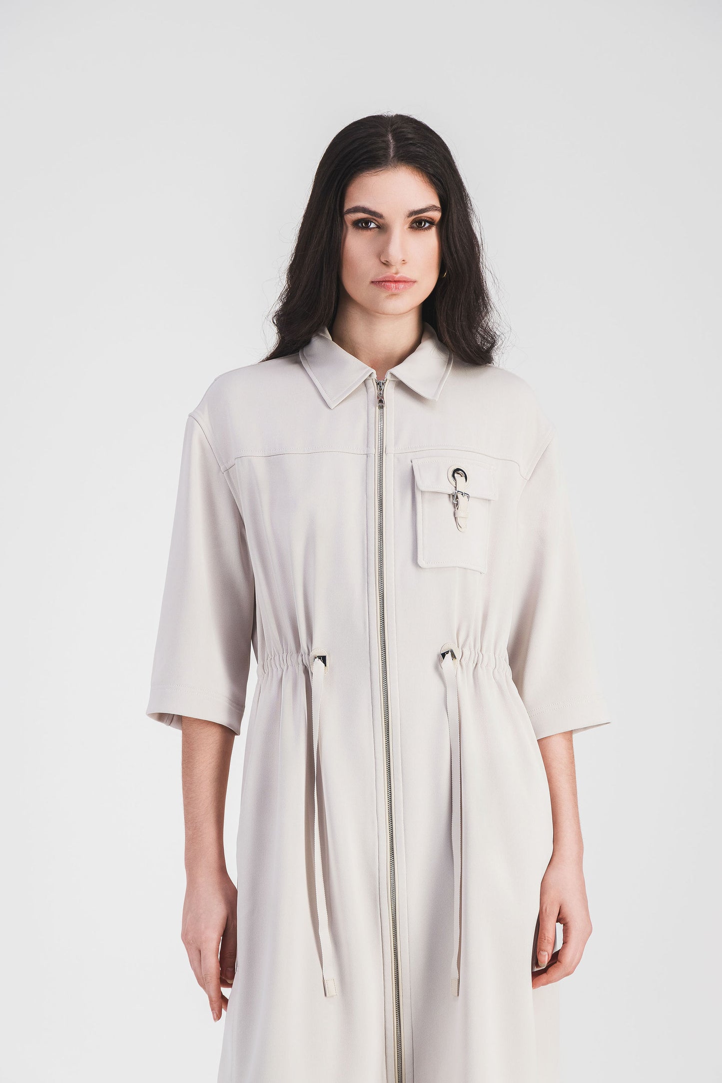 Robe courte surchemise moderne en béton, avec poche plaquée décorée d'une boucle métallique et taille ajustable avec cordon.