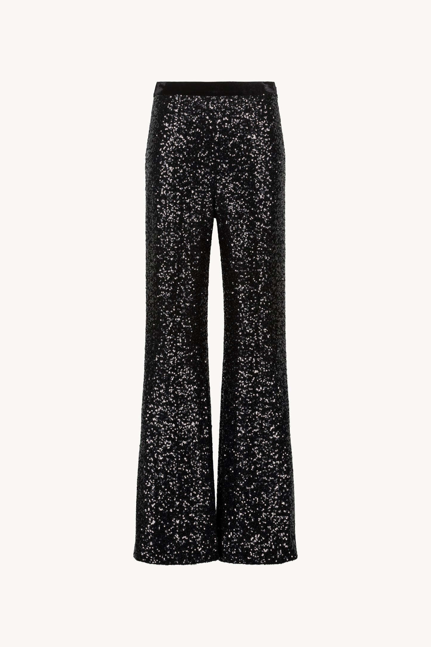 Pantalon droit à sequins. Ceinture velours avec élastique. Zip invisible et fentes sur les côtés.