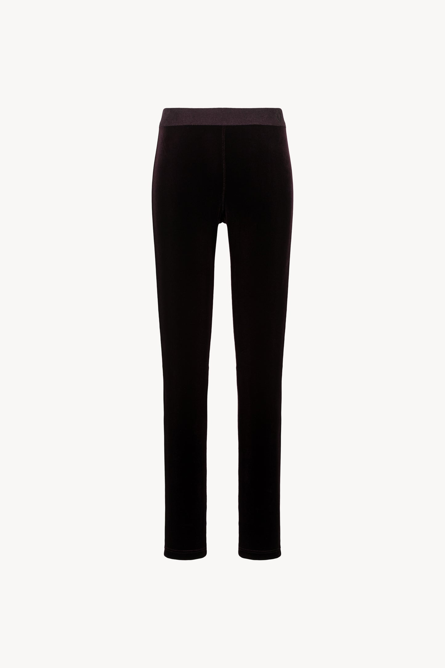 Legging en velours extensible. Ceinture élastique. Fermeture à glissière latérale.