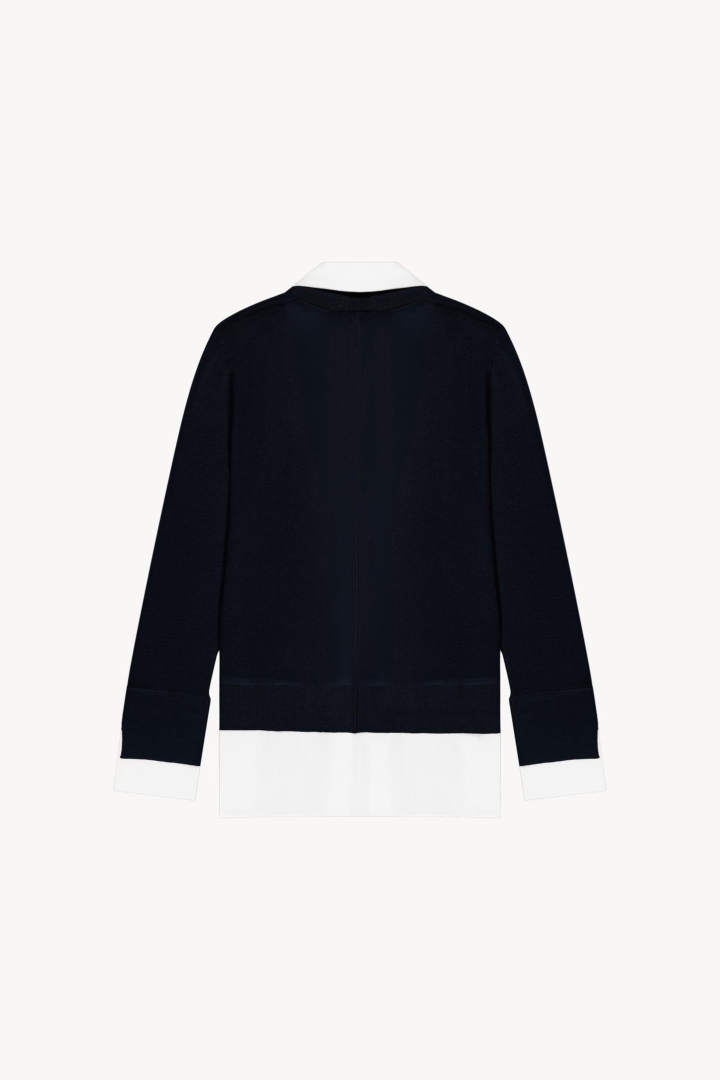 Gilet en laine marine avec des détails popeline et bordures en maille côtelée.