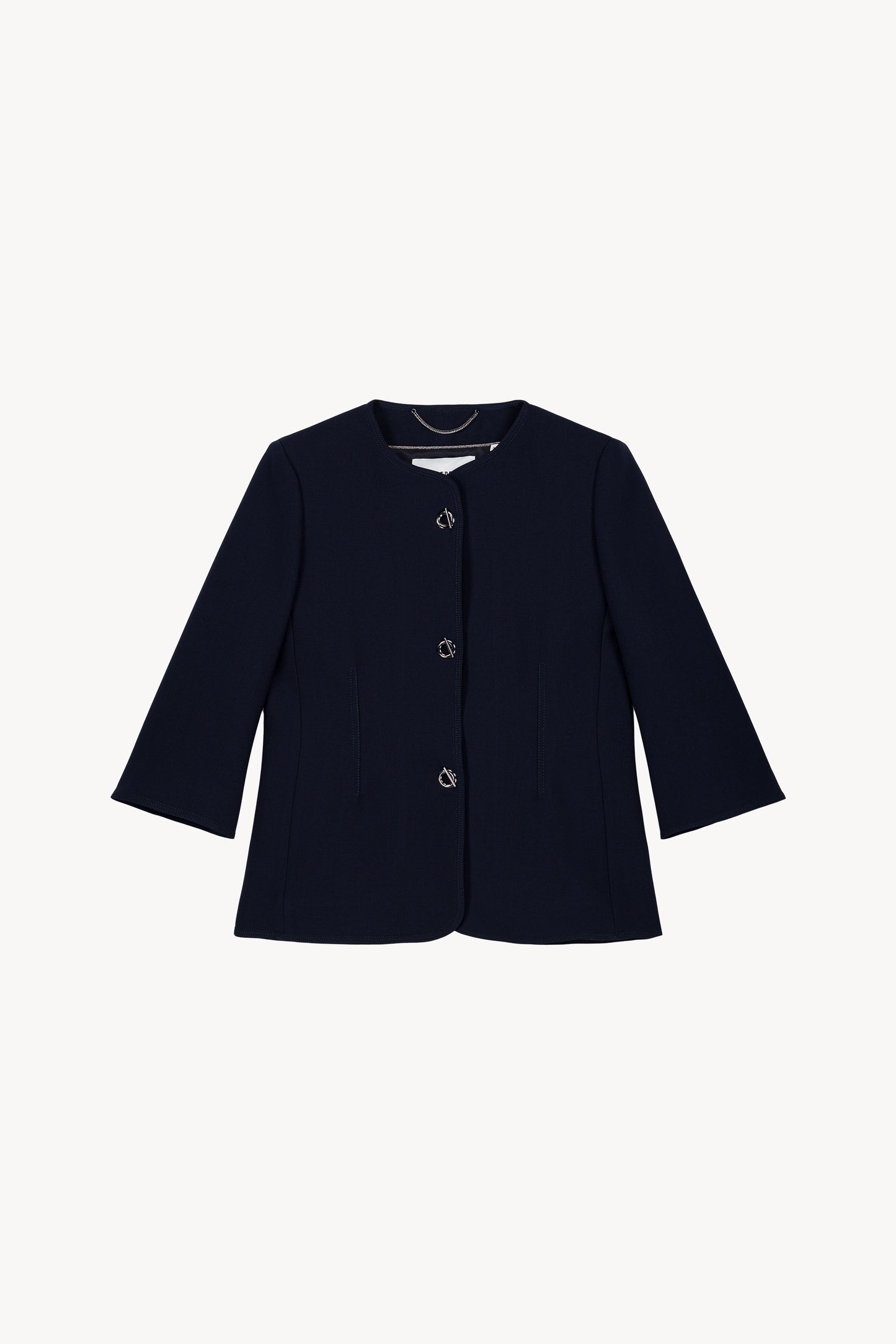 Veste bleu marine à manches 3/4 avec boutons œillet métallisés.