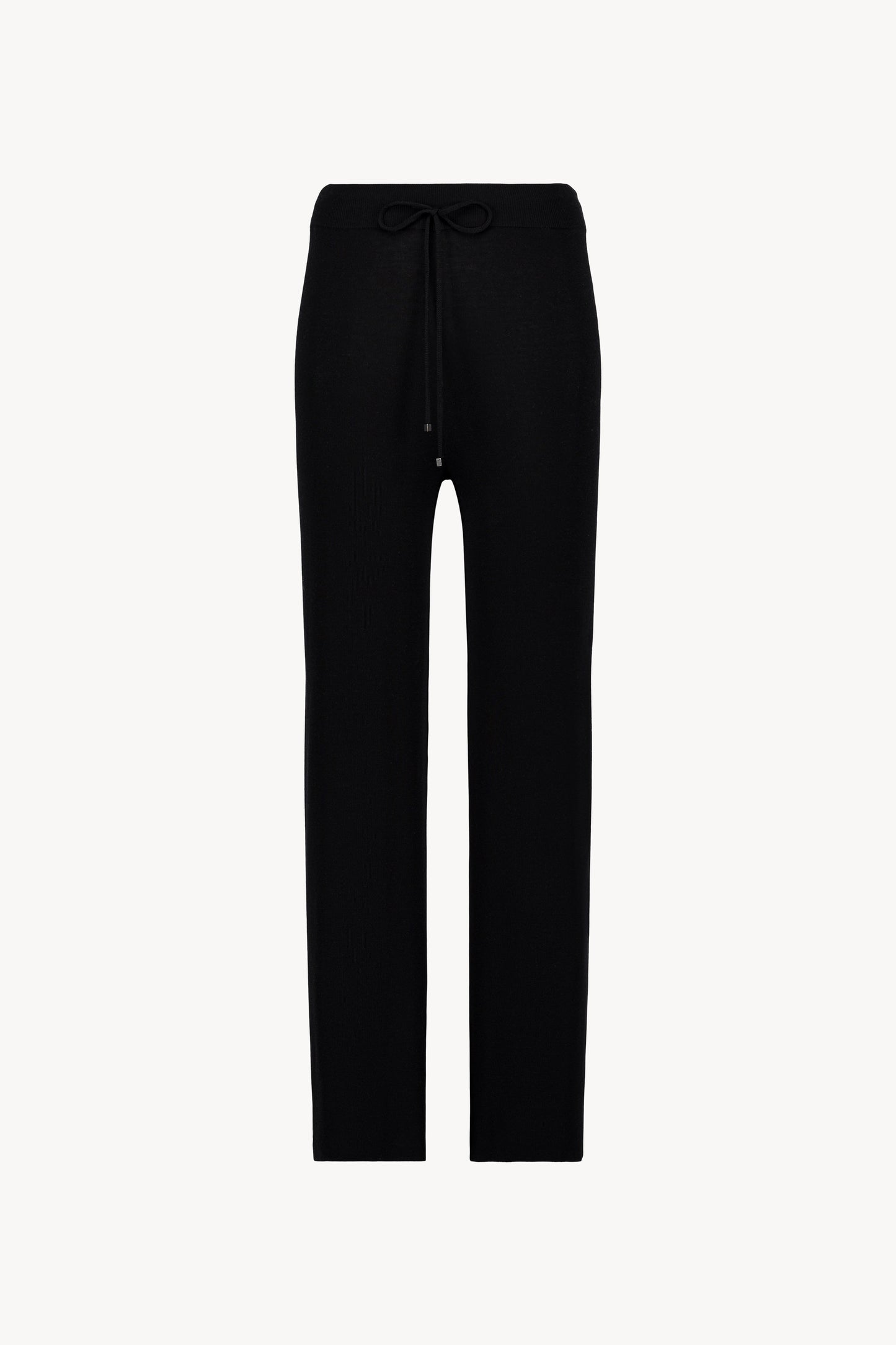 Pantalon en maille à taille élastique et cordon ajustable. Coupe fluide et texture douce