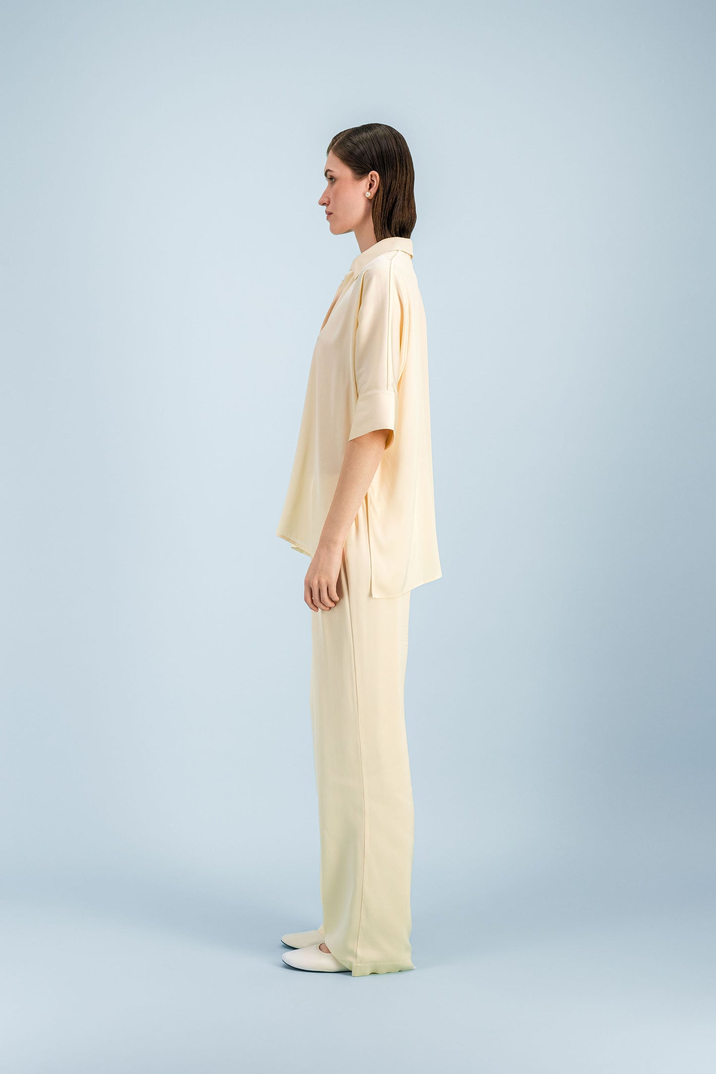 Chemise tunique en soie mélangée jaune clair avec patte de boutonnage cachée et coupe ample.