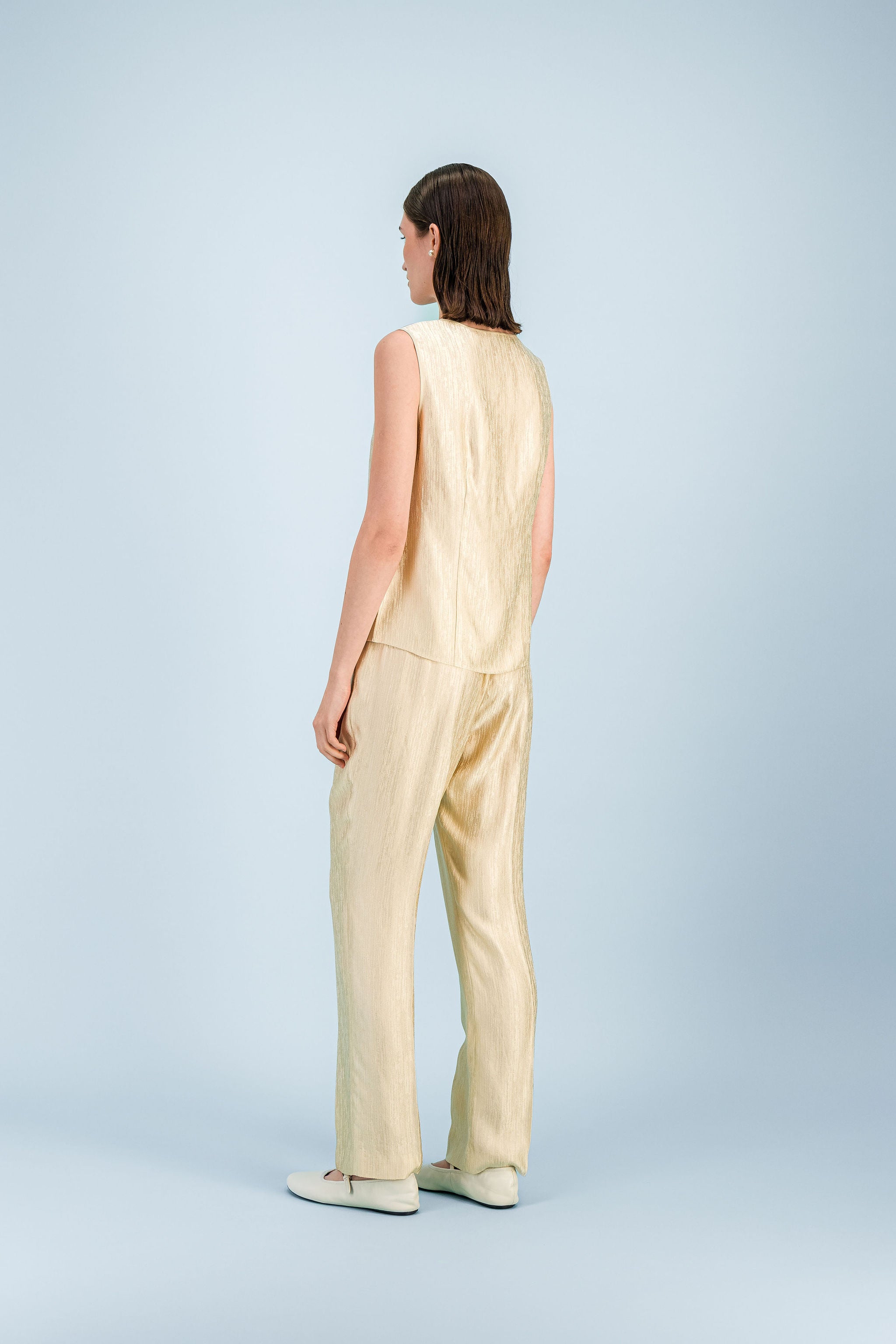 Top femme jaune clair texturé à encolure ronde et ligne épurée.