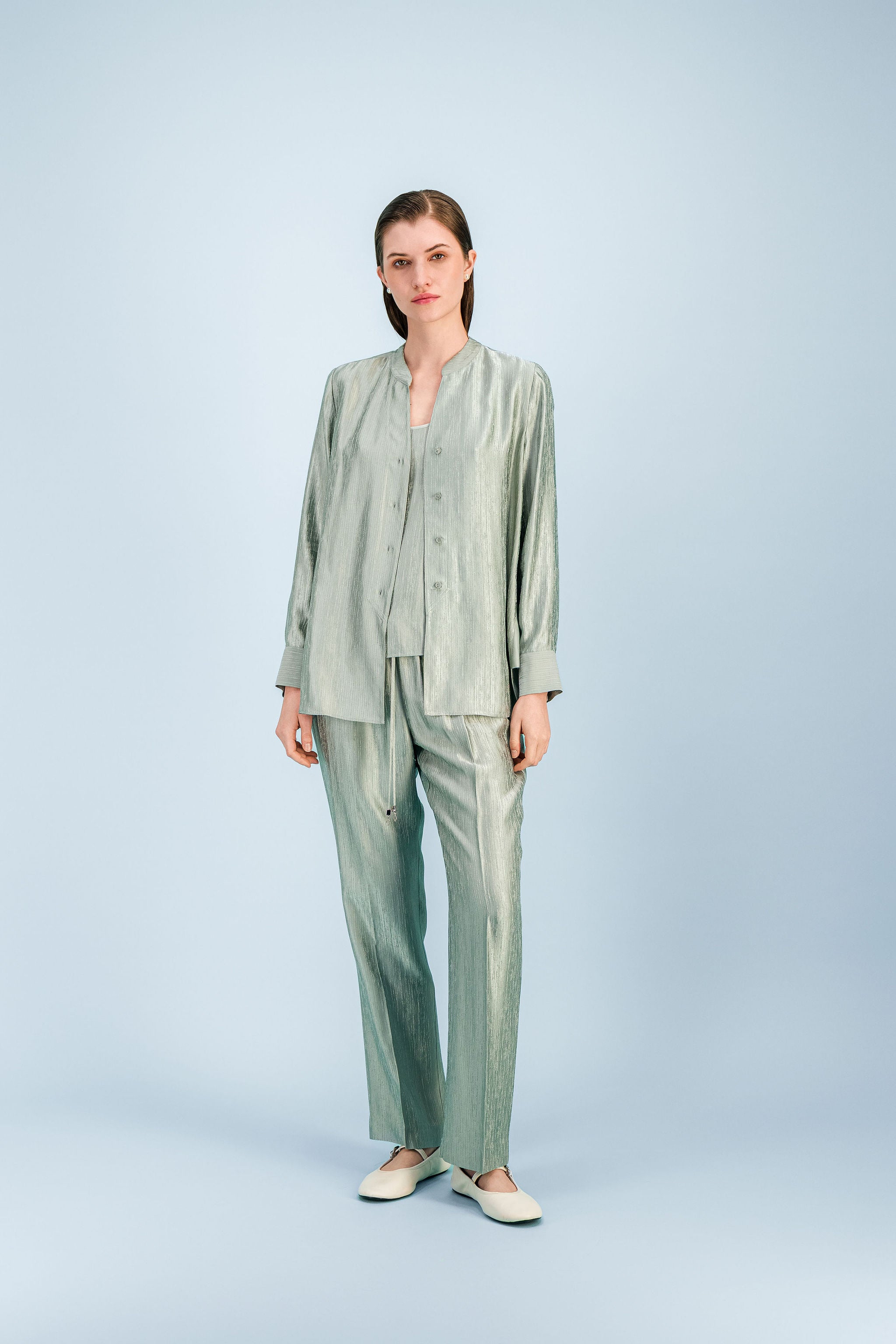 Tunique femme vert sauge à coupe fluide avec col ouvert et manches longues légèrement évasées.