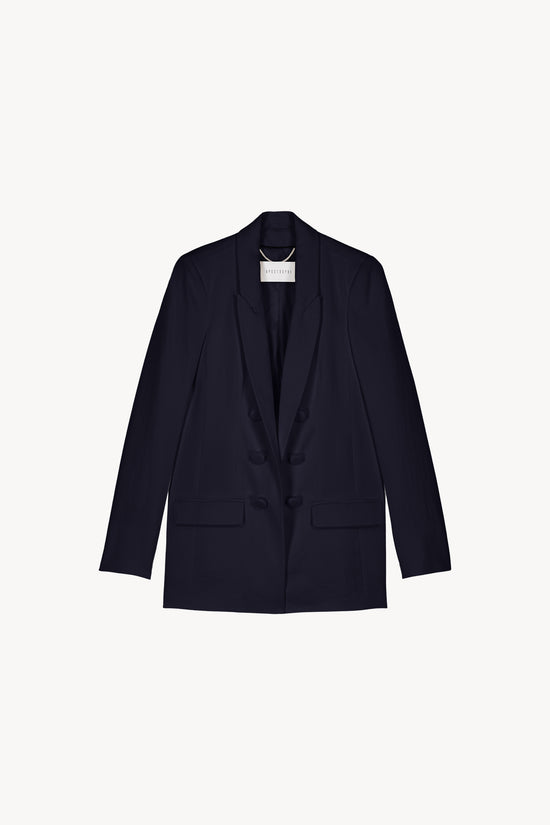 Cette veste cintrée aux finitions en velours allie structure et féminité. Son col cranté et ses poches passepoilées.