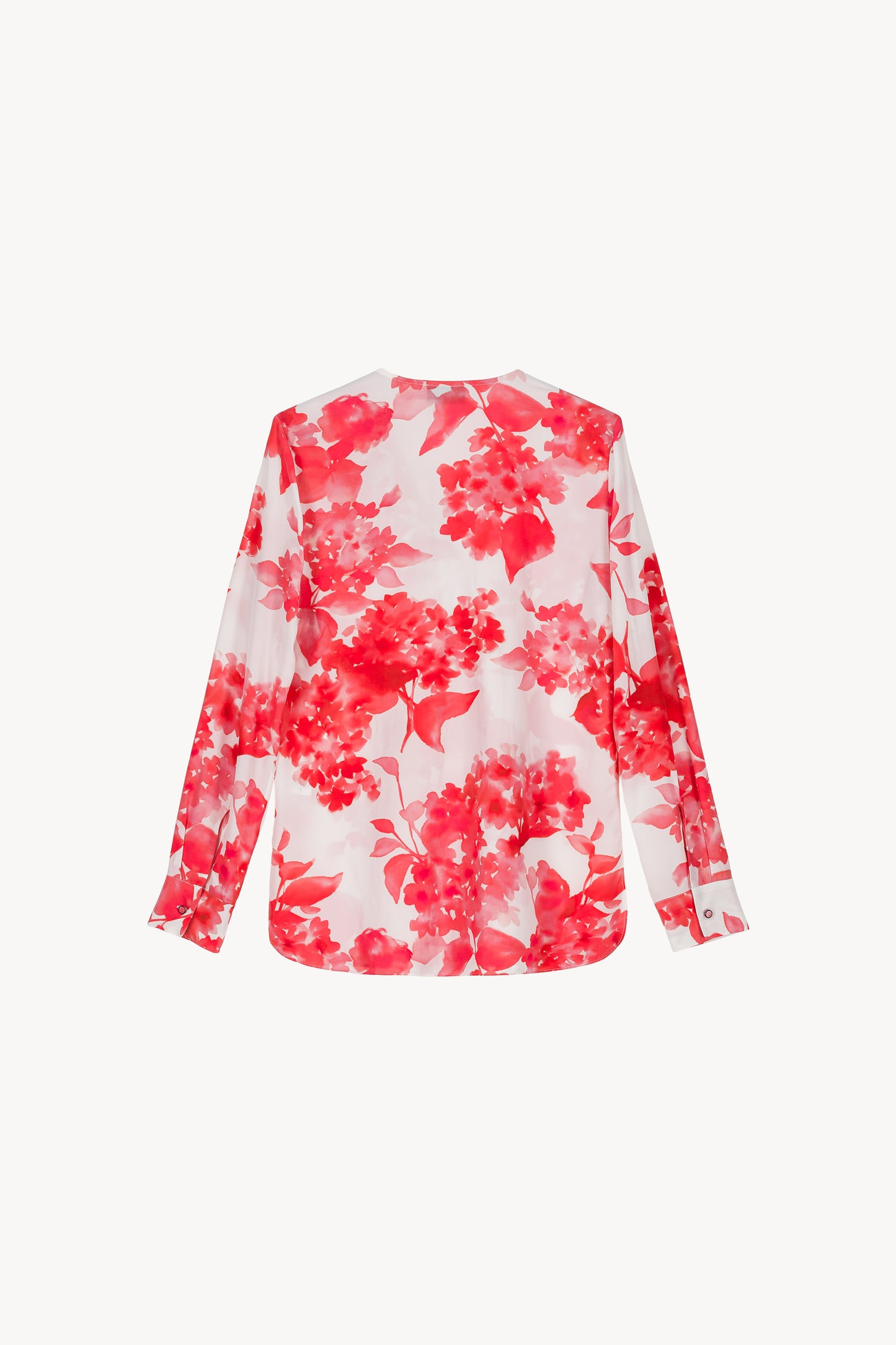 Blouse à volants fleuris corail, fluide et élégante, avec col en V et volants délicats. 