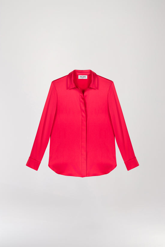 Chemise en satin de soie corail, lumineuse et éclatante, incarnant l'élégance féminine. Sa coupe fluide et son tissu soyeux sont sublimés par une patte de boutonnage cachée, des fentes latérales subtiles et un bas arrondi pour une allure raffinée.