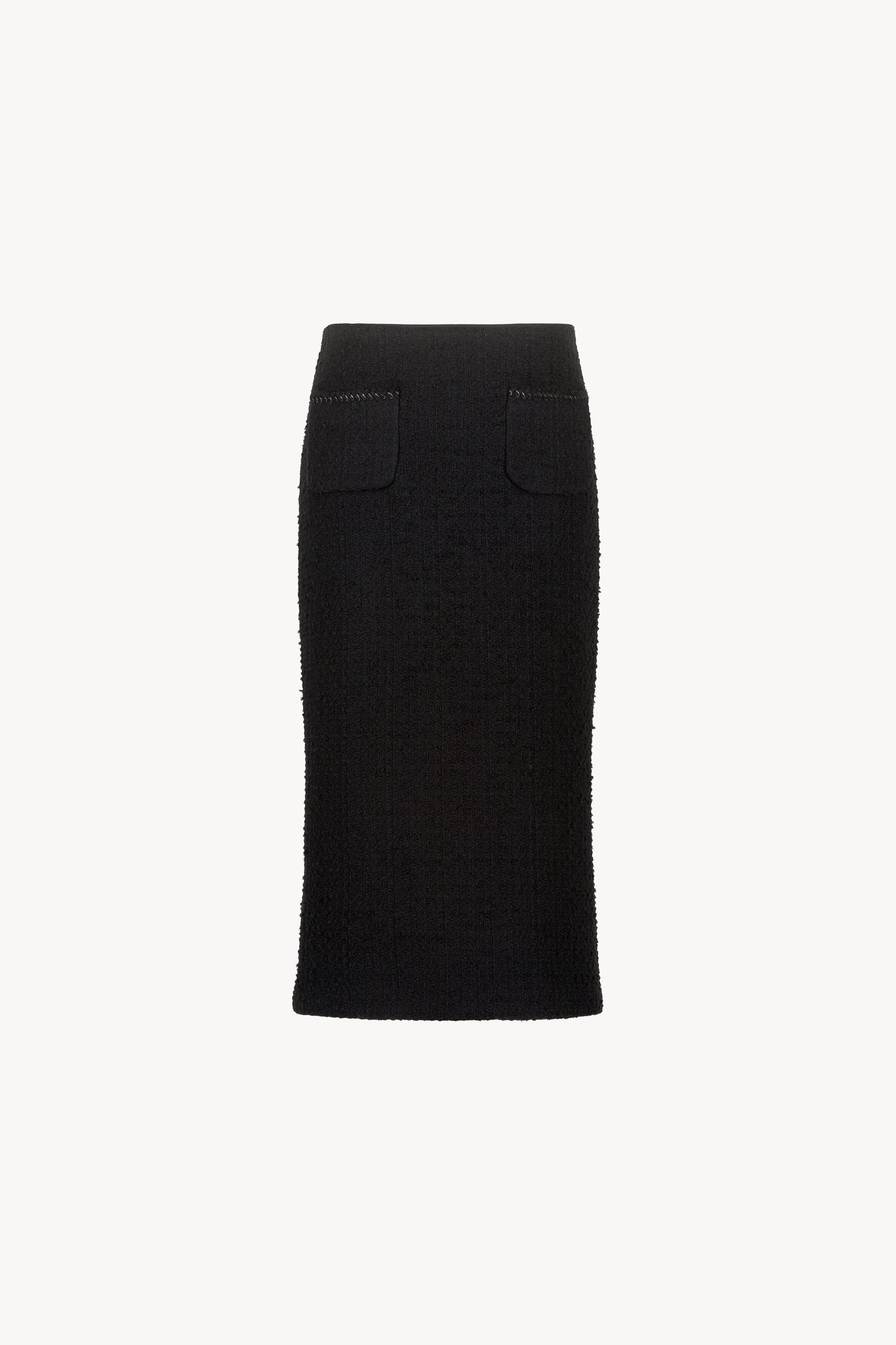 Jupe en tweed noir ornée de poches plaquées, de détails tressés, d'une fente arrière et d'un zip invisible au dos.