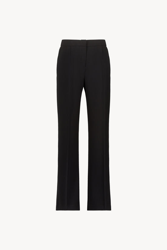 Pantalon droit noir élégant avec ceinture élastique intérieure, poches italiennes et braguette classique.