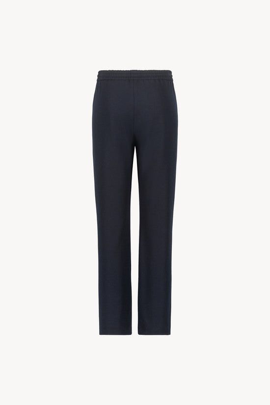 Pantalon marine orné d'une coupe décontractée, avec des jambes fluides et une taille élastique dotée d'un cordon de serrage sur le devant.