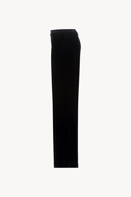 Ce pantalon en velours de soie bleu marine à taille élastique et plis frontaux est la touche sophistiquée.