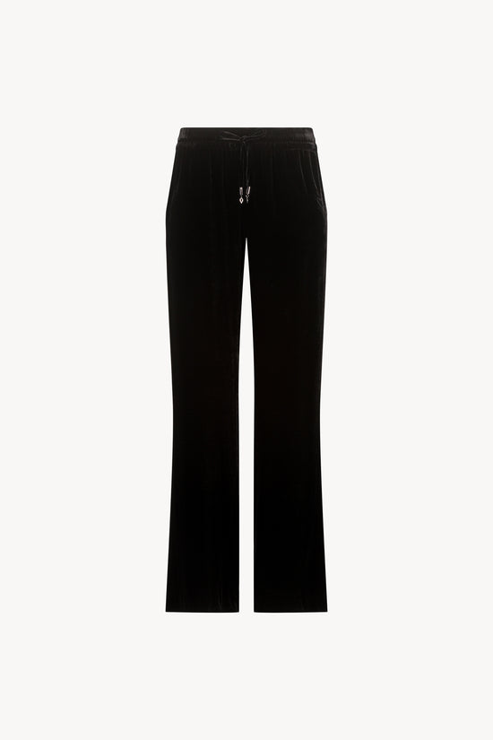 Pantalon taille haute velours noir orné d’une taille élastique avec des cordons de serrage avec les embouts bijoux iconiques Apostrophe et des poches pratiques.