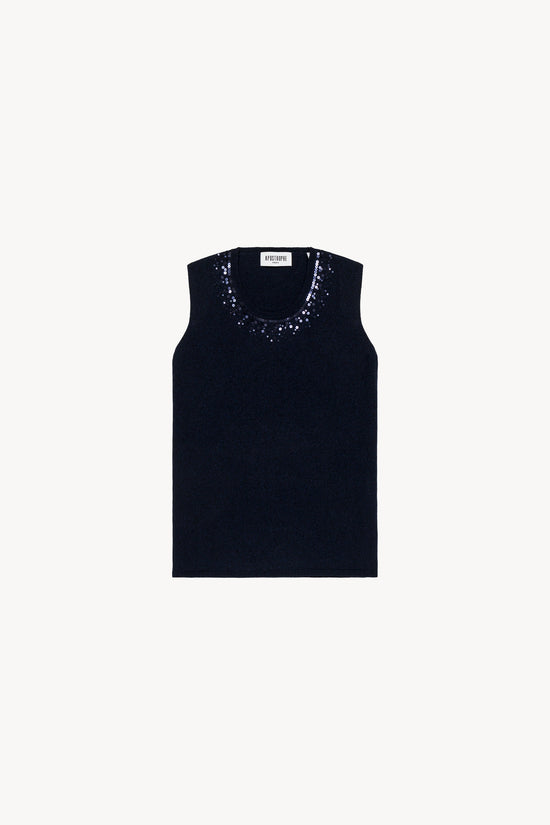 Pull sans manches marine incarne la sophistication à l'état pur. Confectionné en laine fine de qualité, il se distingue par son col rond délicatement orné de paillettes et ses finitions côtelées,