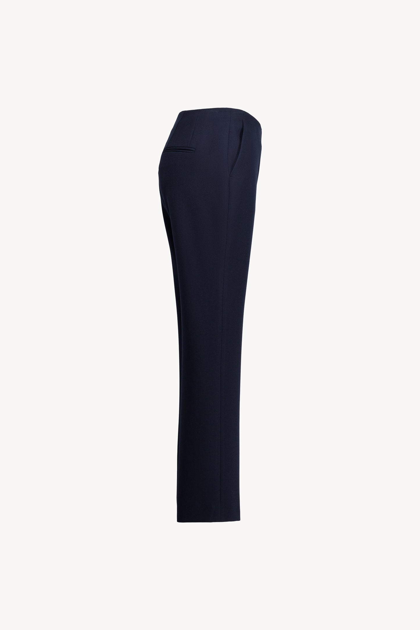 Pantalon droit marine en georgette de soie stretch, mettant en valeur les poches italiennes, les plis plats et les finitions double passepoil au dos.