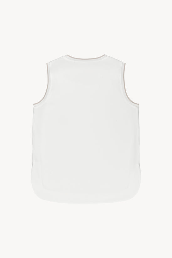 Ce haut blanc fluide et doux offre une coupe droite et des finitions côtelées.