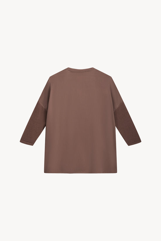 Son col en V, ses manches en jersey et la broderie ton sur ton créent une silhouette raffinée, tandis que la georgette de soie stretch assure une fluidité parfaite.