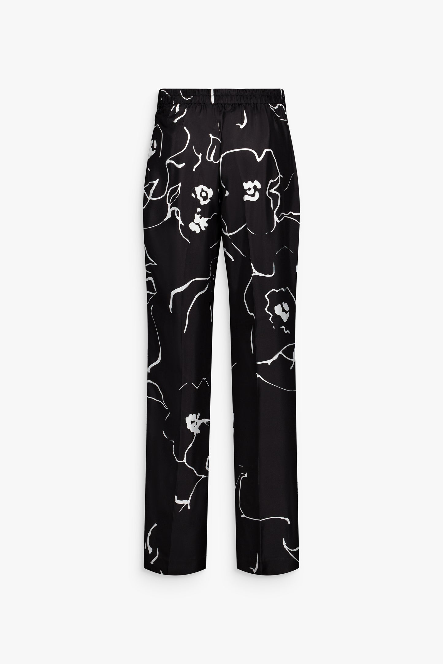 Pantalon droit noir, soie imprimée et silhouette structurée élégante.