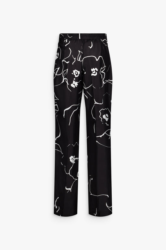 Pantalon droit noir, soie imprimée et silhouette structurée élégante.