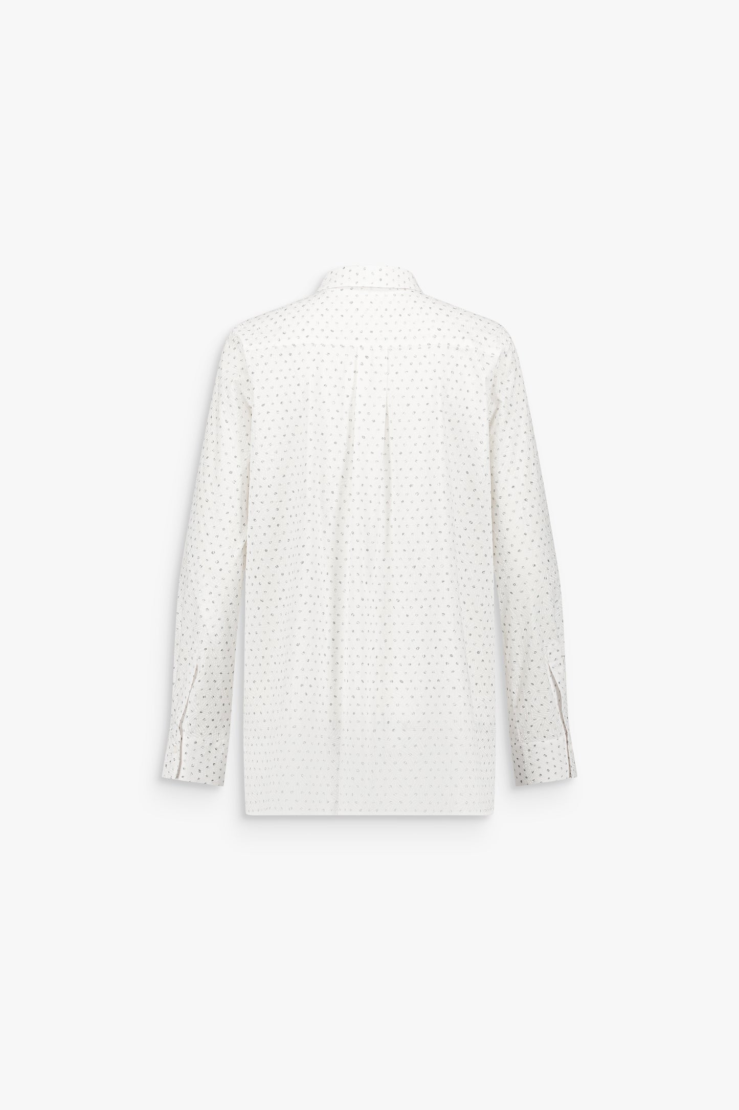 Détail d’une chemise blanc cassé texturée, soulignée par un motif géométrique subtil