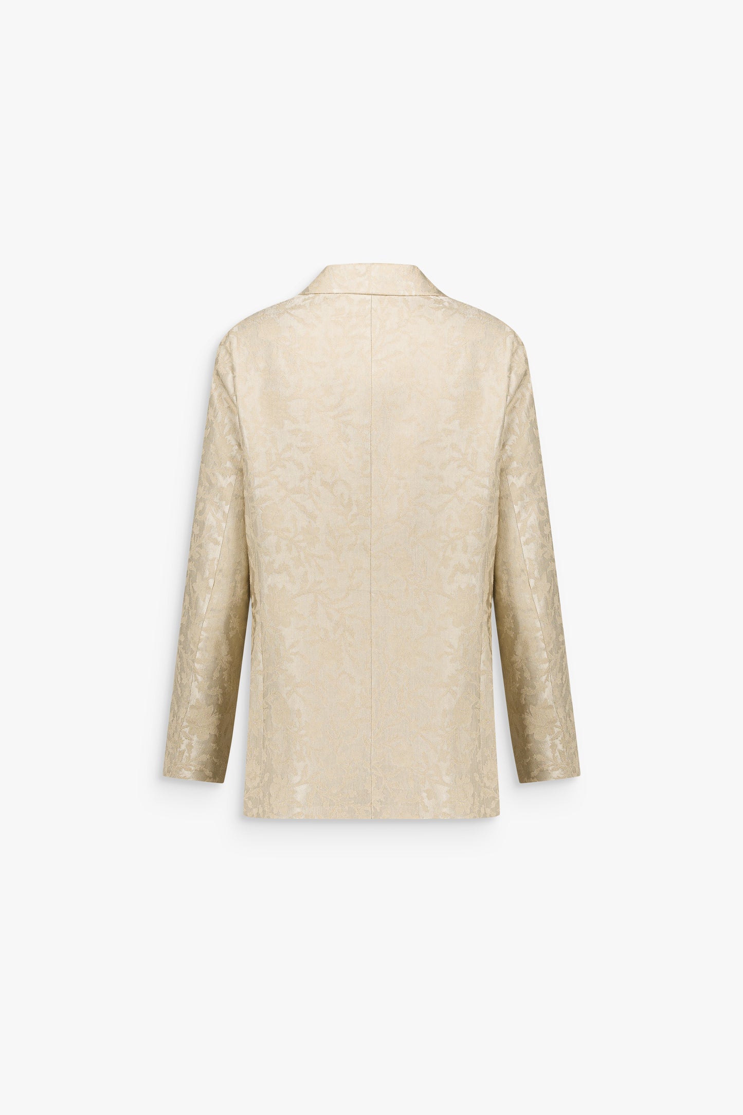 Détail d’une veste en jacquard de lin texturé, révélant un motif floral discret