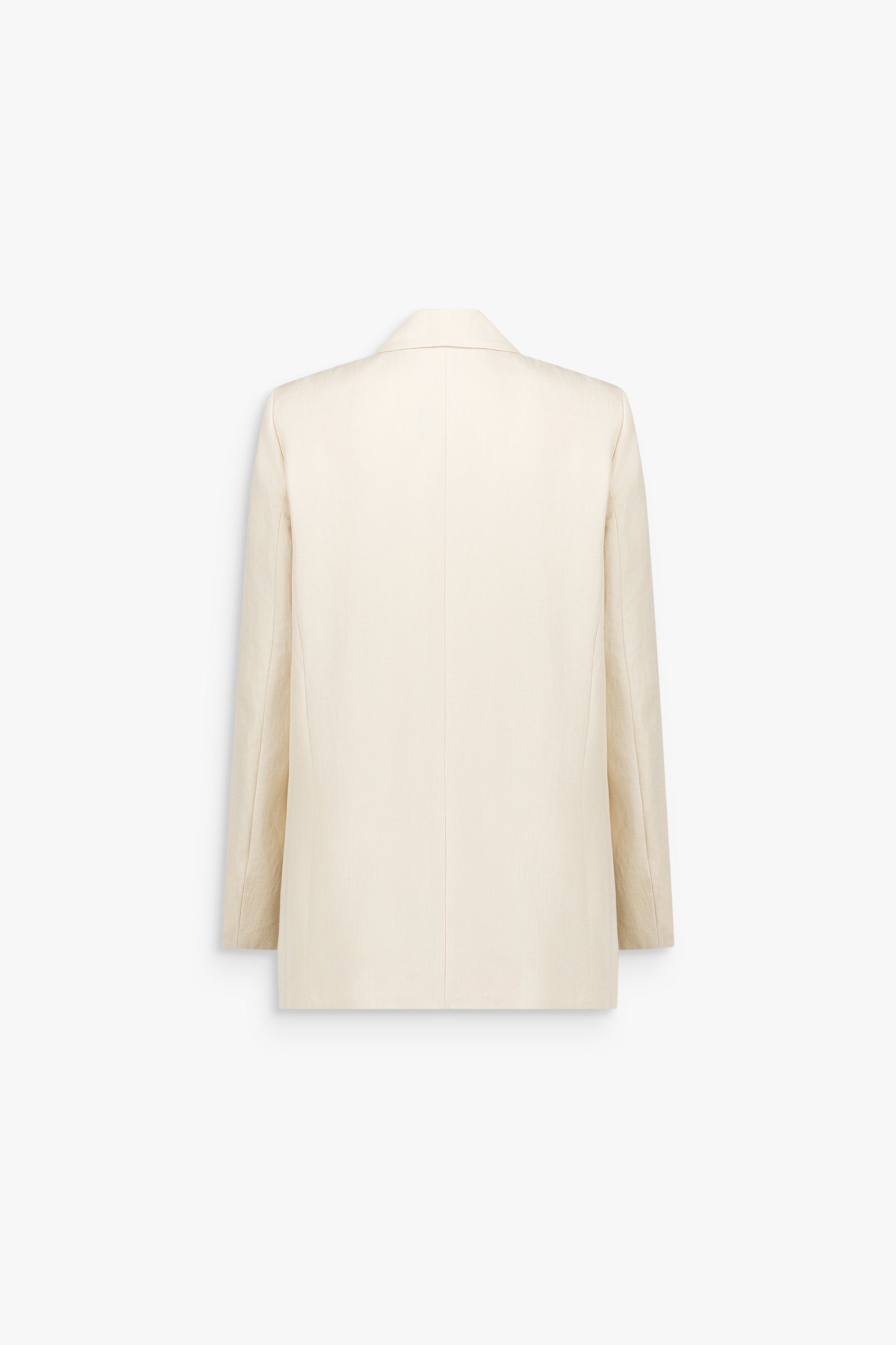 Détail d’une veste tailleur jaune clair, révélant le grain subtil d’un lin mélangé estival.
