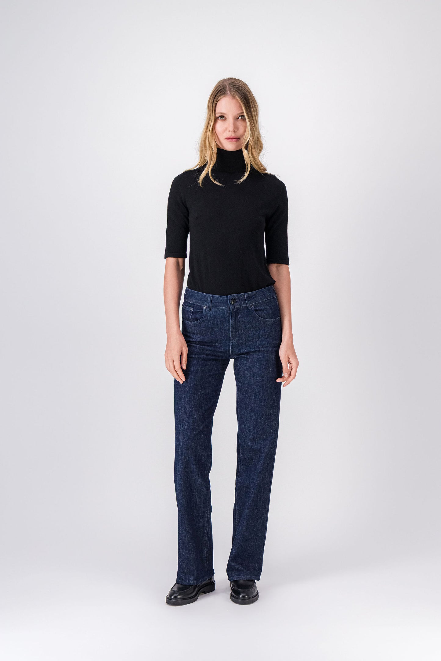 Pull noir en laine à col roulé, coupe droite et légèrement courte pour un style élégant.