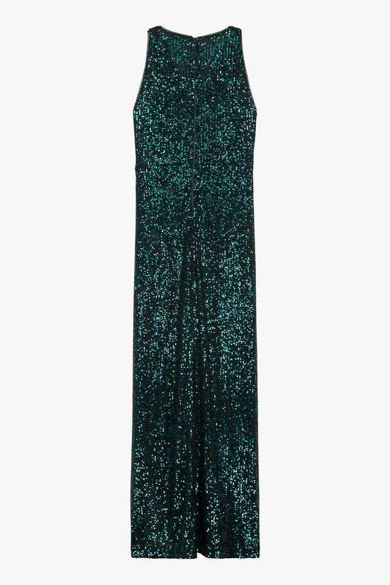 Robe scintillante en sequins, coupe croisée et col V. Fente discrète à gauche. Zip invisible au dos pour une finition élégante.