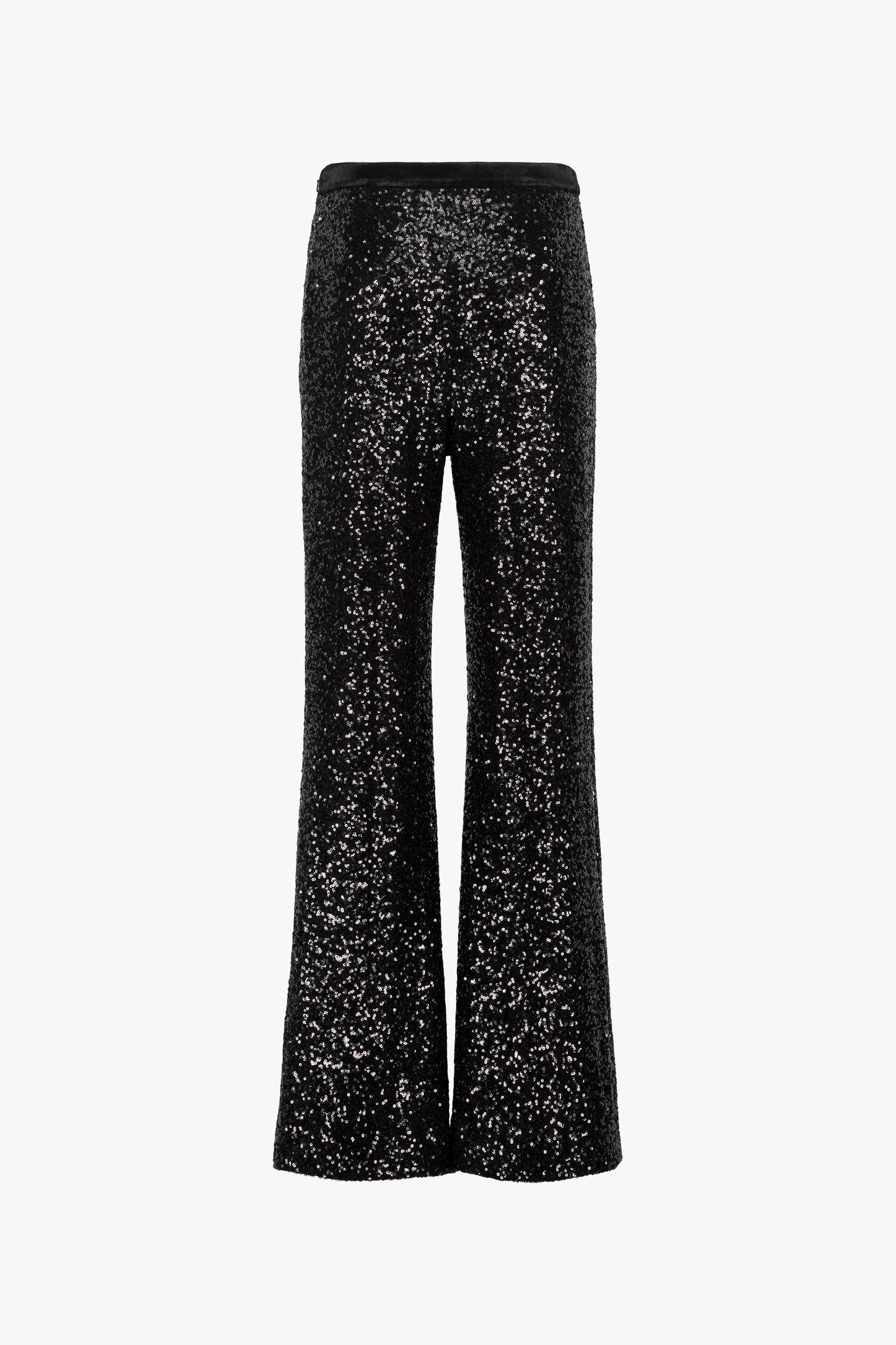 Pantalon évasé à sequins. Taille élastique en velours, zip invisible sur le côté, fentes latérales.