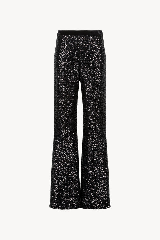 Pantalon droit à sequins. Ceinture velours avec élastique. Zip invisible et fentes sur les côtés.