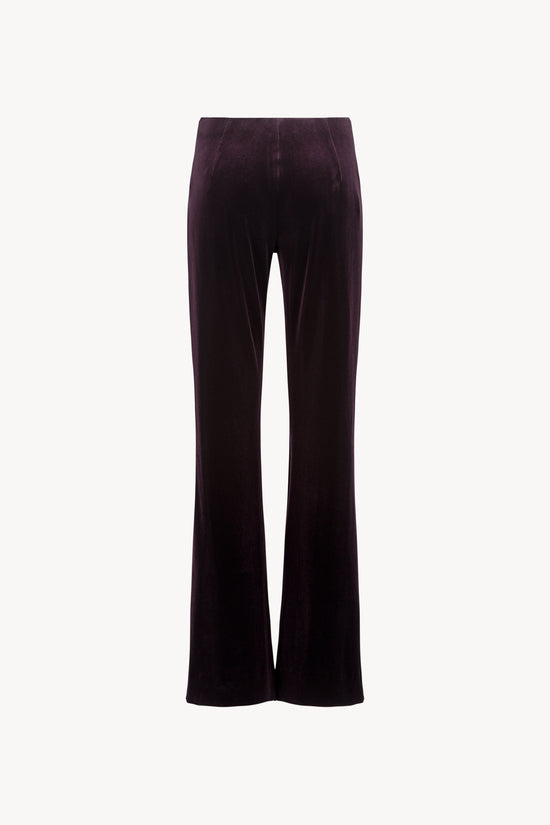 Velours extensible grenat, coupe évasée. Ceinture élastique dissimulée. 