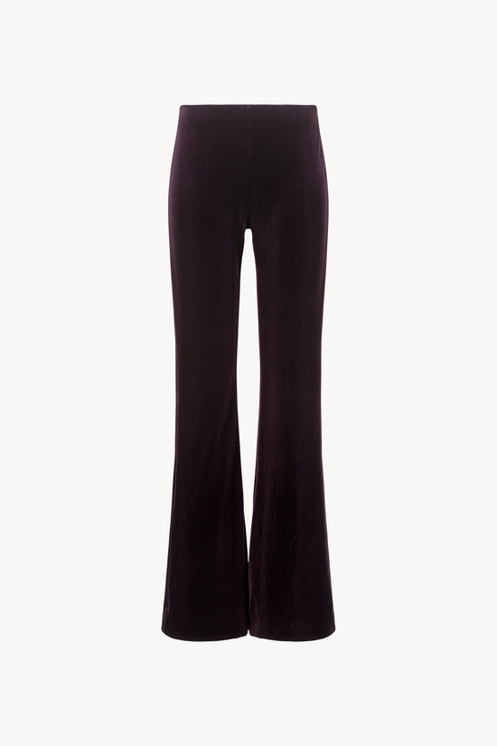 Pantalon évasé en velours extensible. Ceinture élastique cachée. Fermeture à glissière côté.