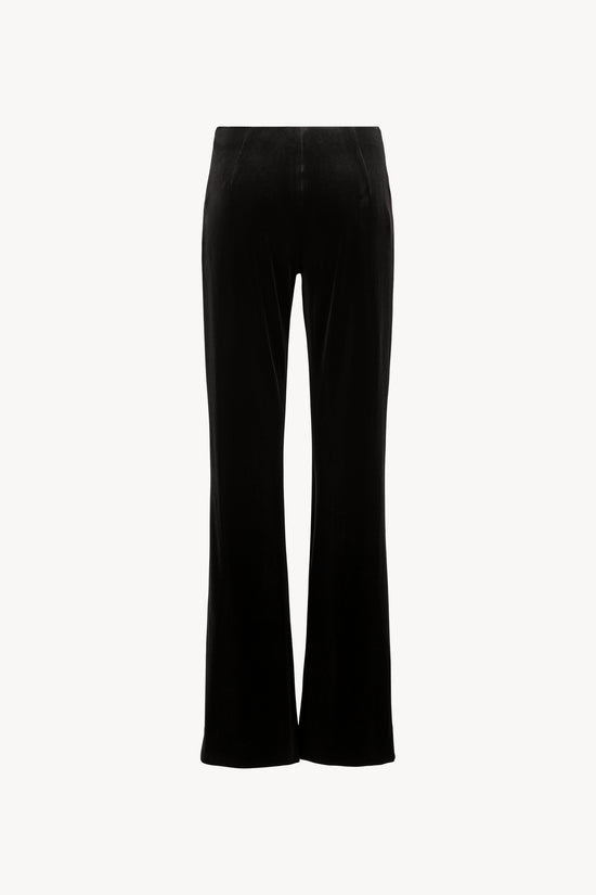 Pantalon en velours, coupe évasée, ceinture élastique cachée, zip invisible latéral.