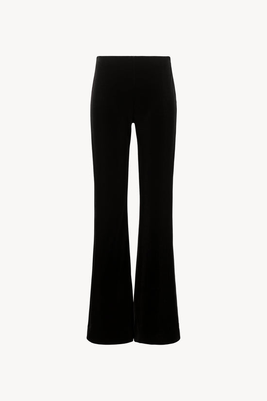 Pantalon évasé en velours extensible, ceinture élastique cachée, fermeture à glissière latérale.