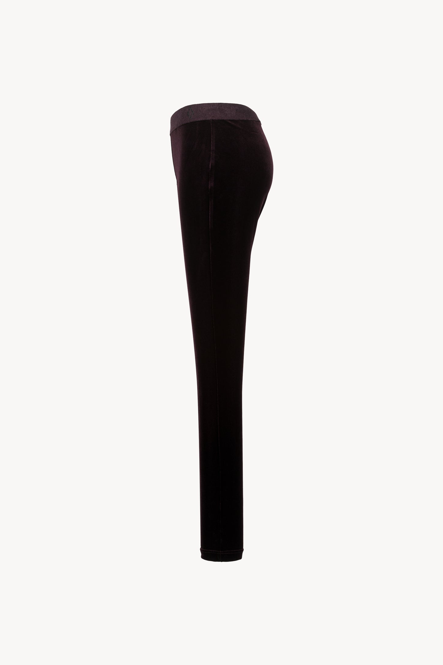 Velours extensible. Coupe moulante, ceinture élastique, zip latéral caché.