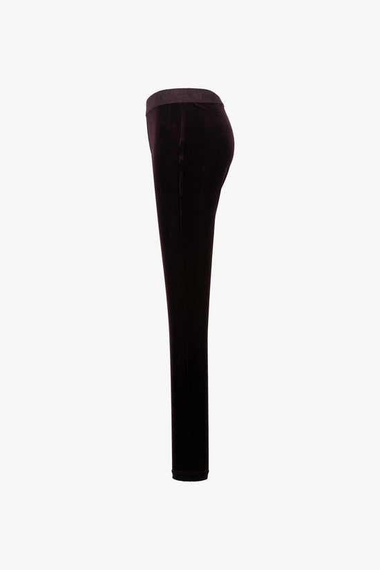 Velours extensible. Coupe moulante, ceinture élastique, zip latéral caché.