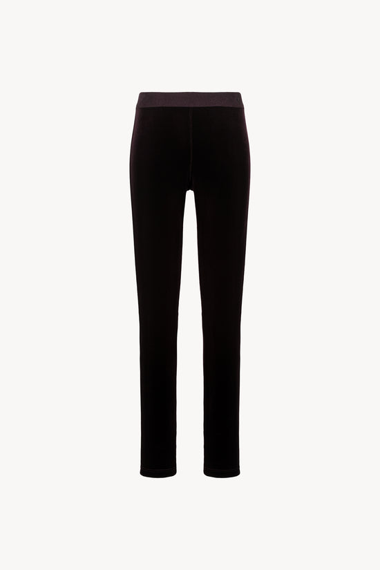 Legging en velours extensible. Ceinture élastique. Fermeture à glissière latérale.