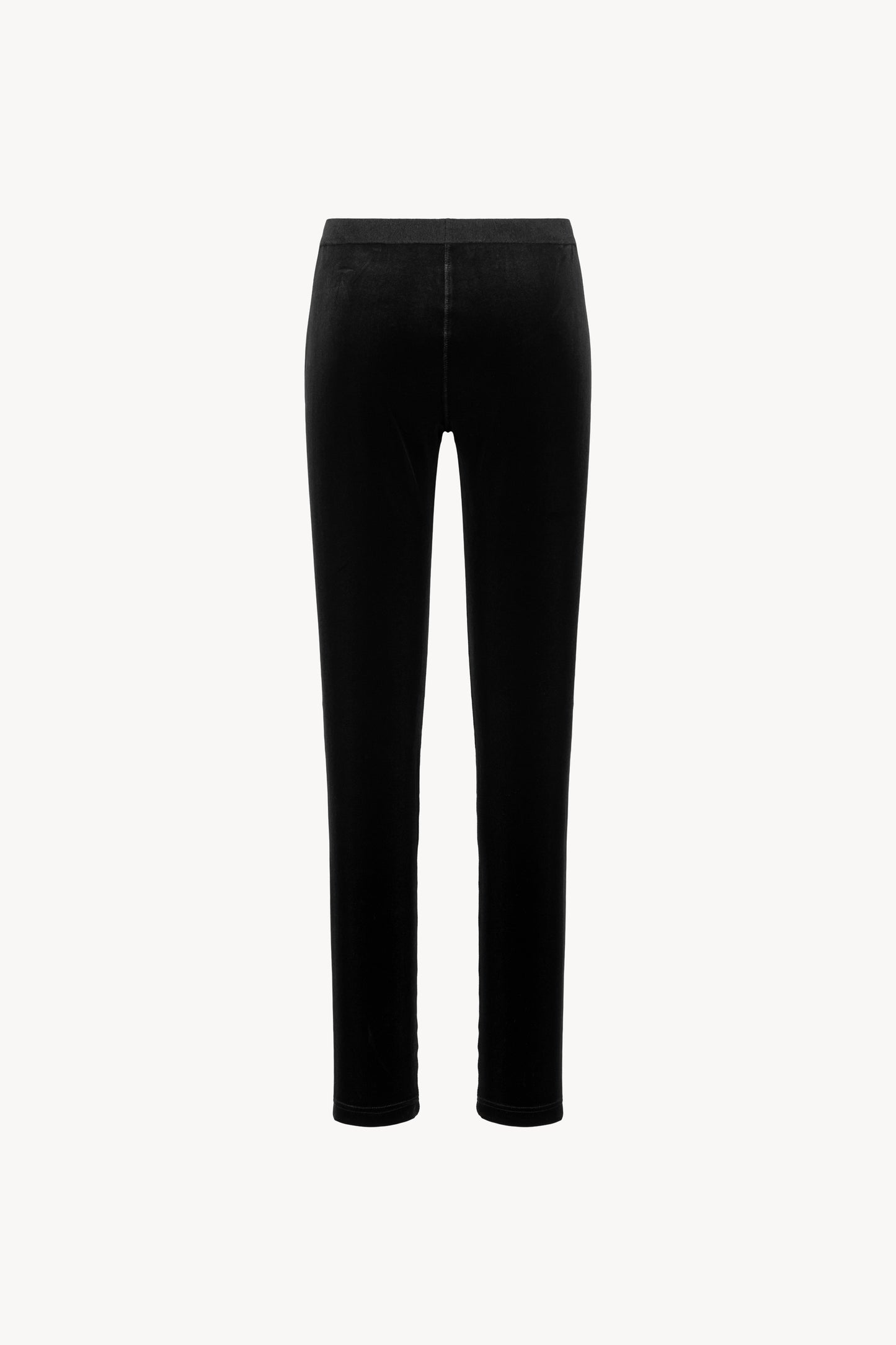 Tissu velours extensible. Ceinture élastique, coupe ajustée. Fermeture zippée sur le côté.
