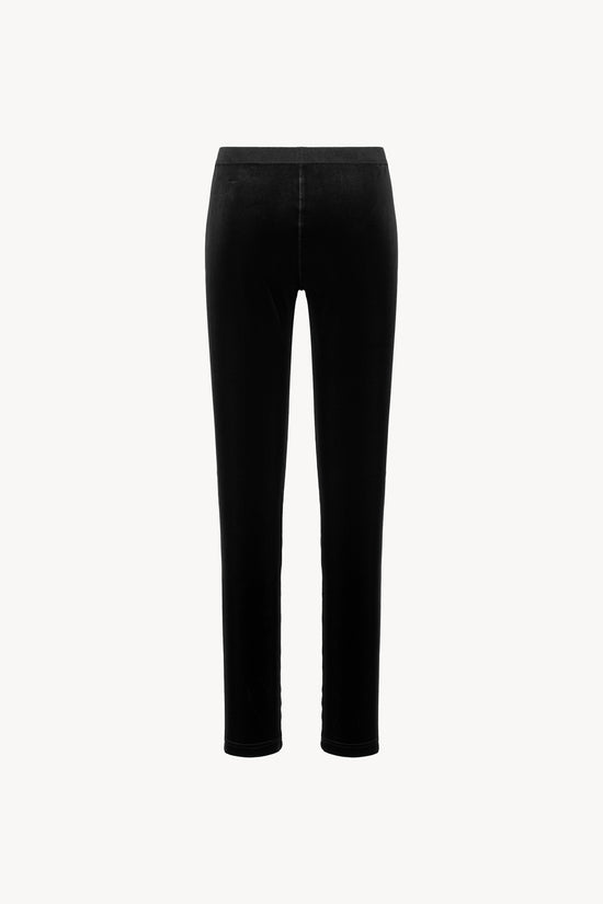 Tissu velours extensible. Ceinture élastique, coupe ajustée. Fermeture zippée sur le côté.