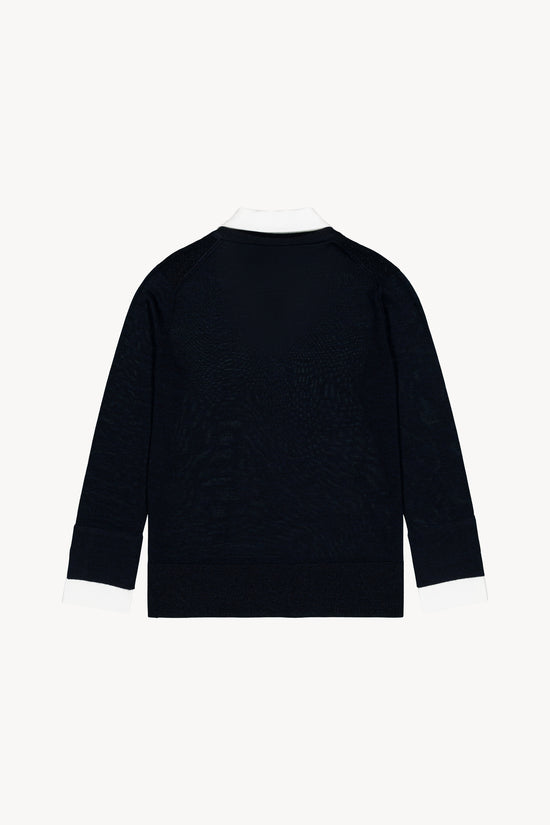 Maille superposé Col chemise en popeline. Incrustations lurex aux épaules. Finitions fendues sur les côtés.