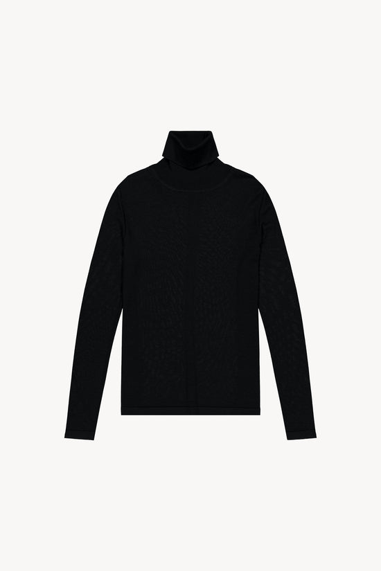 Pull en maille fine laine mérinos. Col roulé, manches longues, jeu de maille structuré au dos.