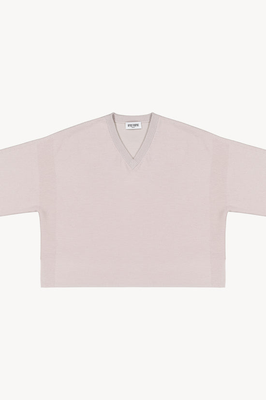 Pull oversize en laine beige avec un col en v et des manches 3/4