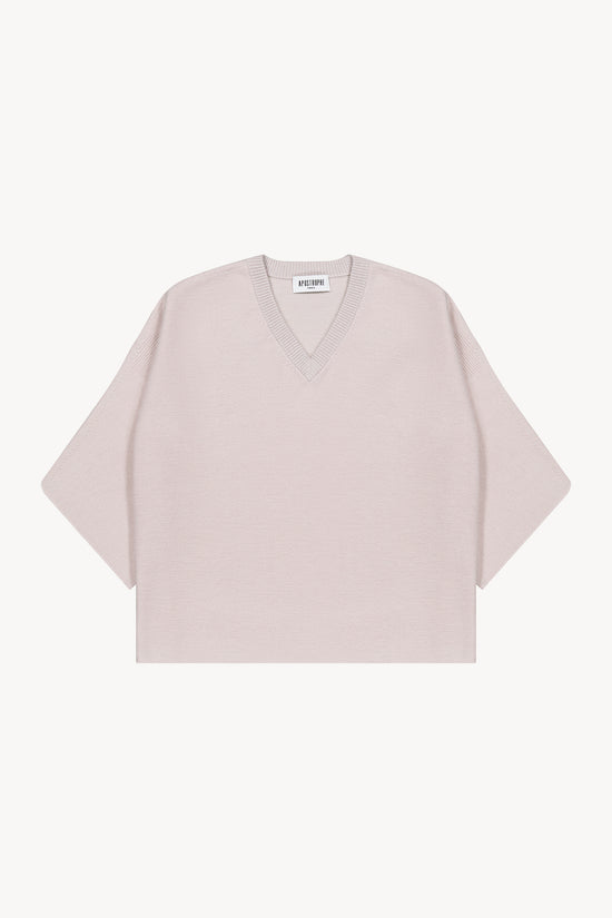 Pull oversize en laine. Col V en maille lurex. Manches 3/4. Finitions côtelées. Fentes latérales.