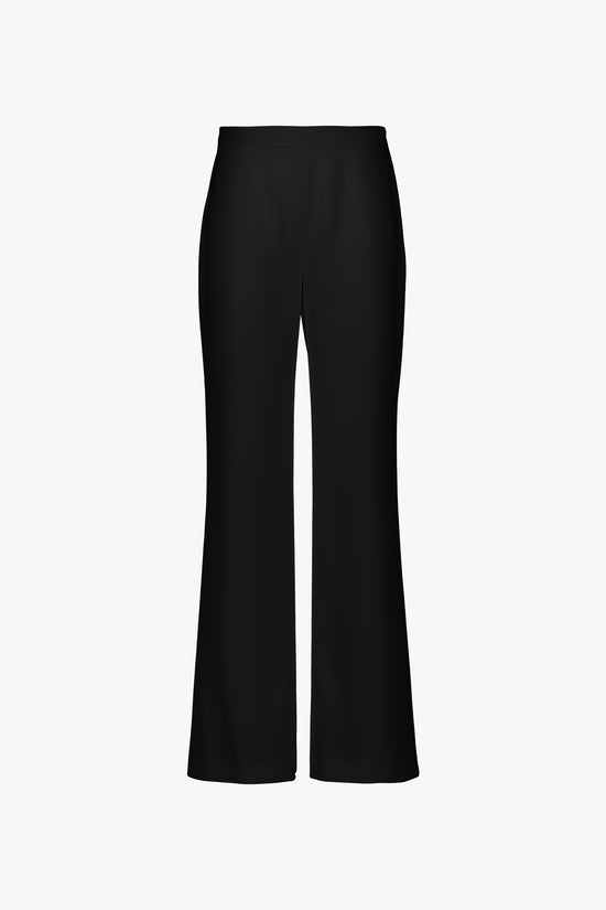 Pantalon noir avec une coupe évasée. Taille structurée par pont boutonné. Fermeture invisible.