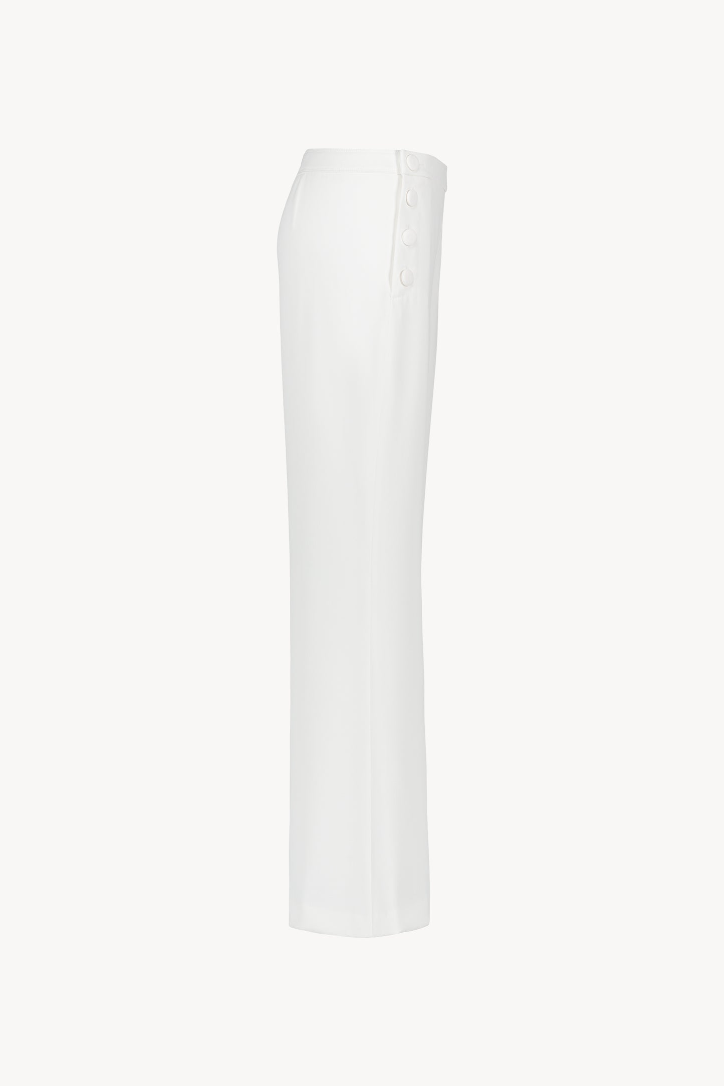 Pantalon blanc avec  coupe évasée et fermeture zippée ton sur ton sur le côté 