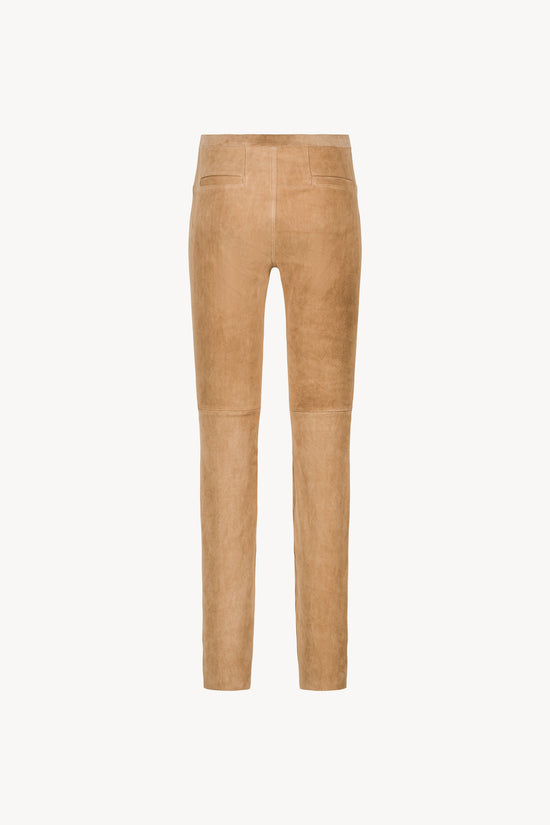 Legging ajusté en daim beige avec fausses poches plaquées avant et arrière. Taille élastique .

